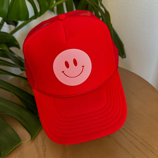 the trucker - light pink smiley on red