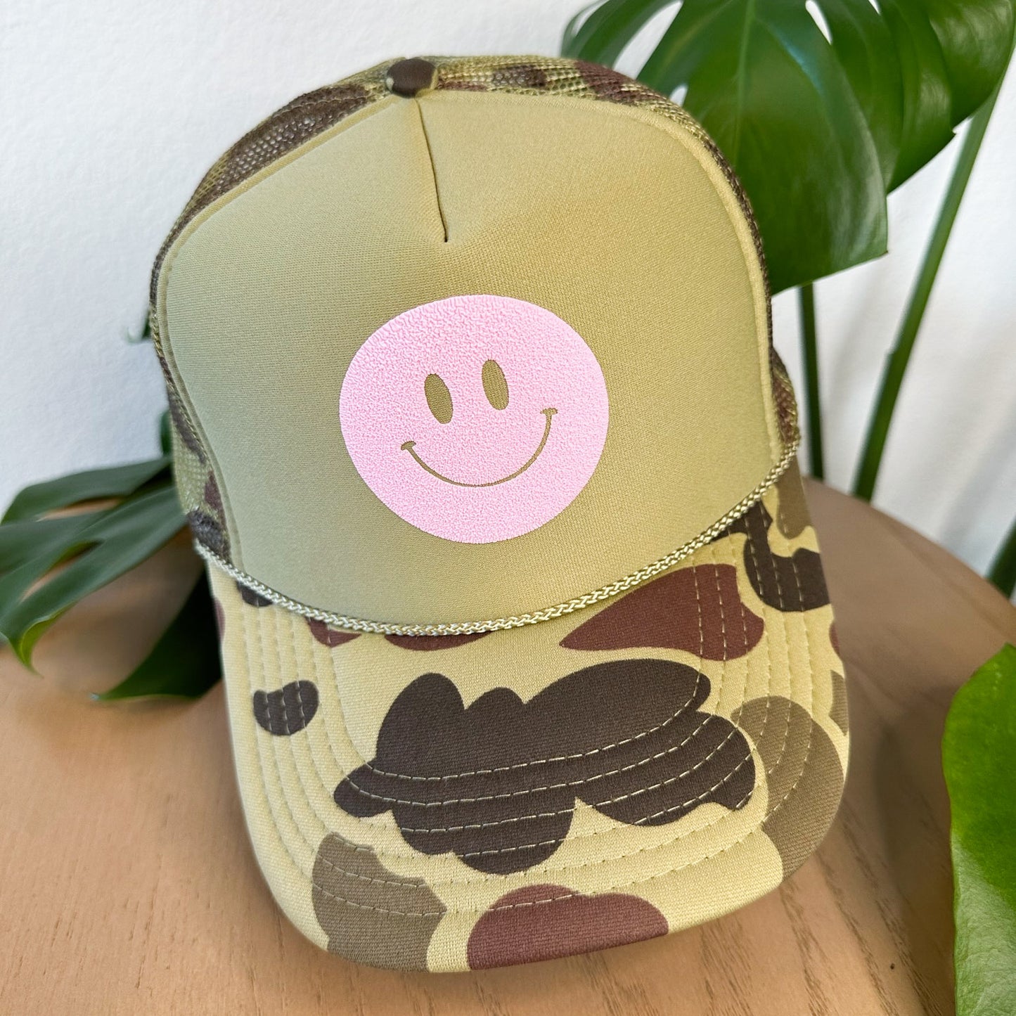 the trucker - light pink smiley on light camo