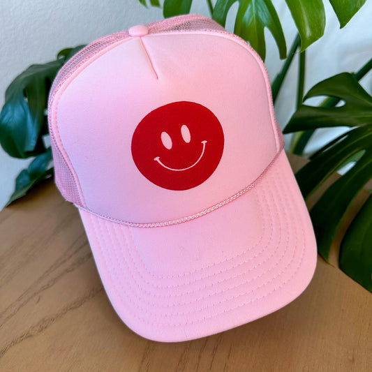 the trucker - red smiley on light pink