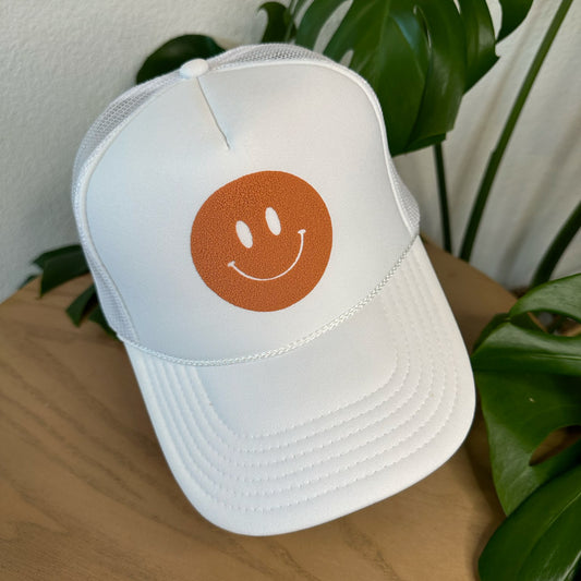 the trucker - rust smiley on white